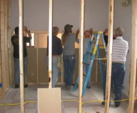 Volunteers framing an interior wall during a church building project